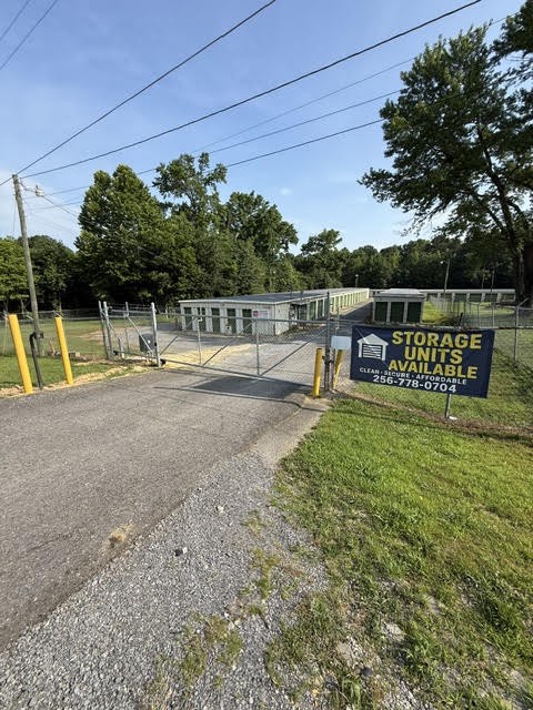 Fenced entrance gate at Smart Stop Mini Storage with a storage units available sign